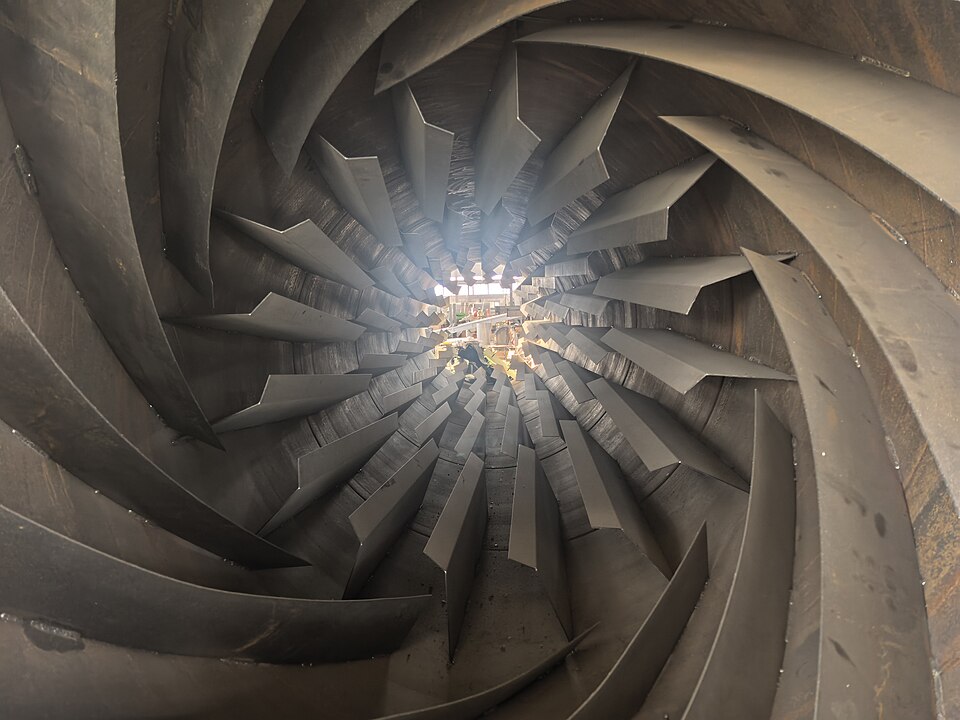 The interior lifting plates of an industrial rotary dryer